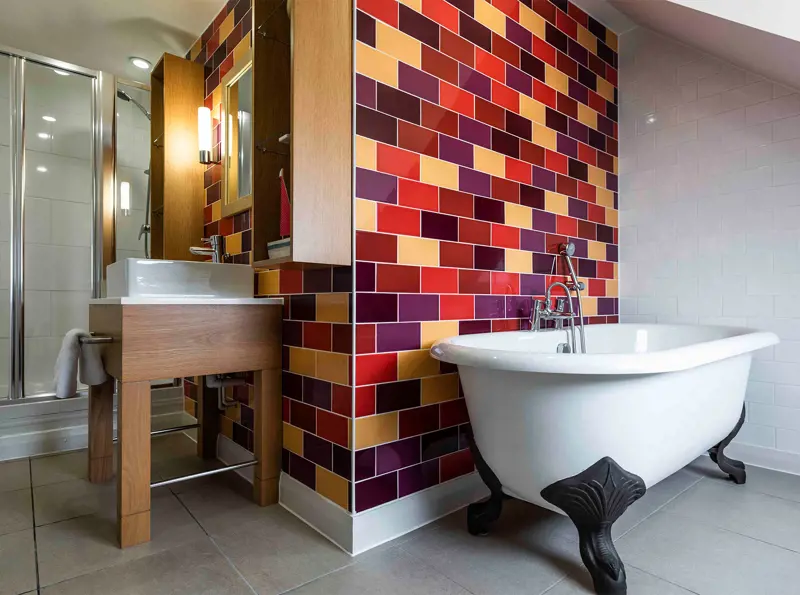 Superior Aldeburgh bathroom at The Brudenell Hotel, Aldeburgh. Rolltop bath with shower.