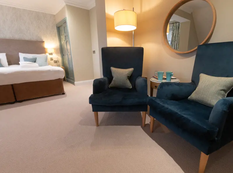 Superior Aldeburgh bedroom with lounge area at The Brudenell Hotel in Aldeburgh